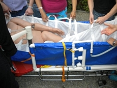 Cryonics UK team carrying a dummy